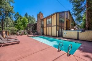 a house with a swimming pool in front of a house at Best Western Stagecoach Inn in Pollock Pines