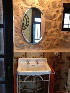 a bathroom with a sink and a mirror at La Casita Del Castañar in Béjar