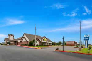 a house on a street with a gas station at Best Western Okmulgee in Okmulgee