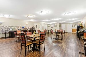 a restaurant with tables and chairs and a bar at Best Western Okmulgee in Okmulgee