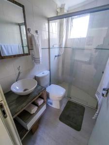a bathroom with a sink and a toilet and a shower at Apto com piscina privativa no centro in Balneário Camboriú +17 photos