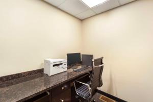 an office with a desk with a computer and a printer at Best Western Plus Peace River Hotel & Suites in Peace River