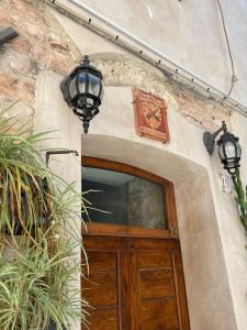 a building with a wooden door and two lights at Affittacamere A Modo Mio in Foligno
