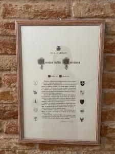 a picture in a frame hanging on a brick wall at Affittacamere A Modo Mio in Foligno
