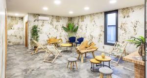 a room with chairs and tables in a room at Best Western Amarys Hotel & Spa in Rambouillet