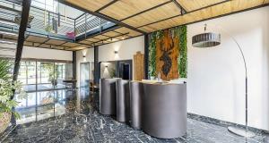 a lobby with a row of tables in a room at Best Western Amarys Hotel & Spa in Rambouillet