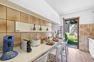 a kitchen with a counter with a coffee maker at Il Giardino di Riva - Happy Rentals in Riva del Garda
