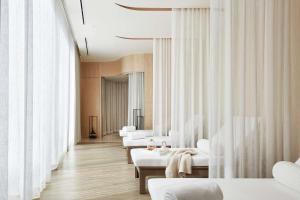 a waiting room with white beds and curtains at Park Hyatt Bangkok in Bangkok
