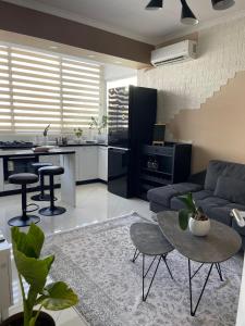 a living room with a couch and a table at Edion Center Apartment in Shkodër