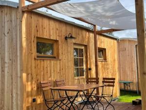 a wooden patio with a table and chairs in front of a building at Tinyhaus Nuss in Mehring