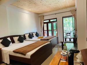 a hotel room with two beds and a couch at Wild Resort Ella in Ella