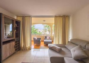 a living room with a couch and a chair at Sunny Ocean View Terrace 3BR Retreat by the Ocean Costa Adeje in Callao Salvaje