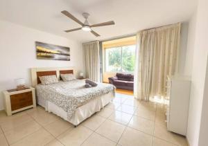 a bedroom with a bed and a ceiling fan at Sunny Ocean View Terrace 3BR Retreat by the Ocean Costa Adeje in Callao Salvaje +61 photos