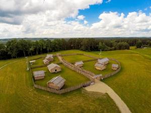 an aerial view of a group of huts in a field at Gallery Guest Rooms in Kernavė