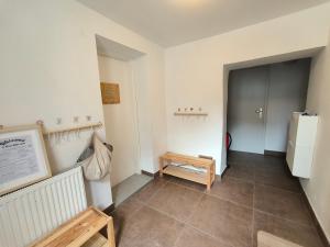 a room with a hallway with a refrigerator and a table at Glasbeni atelje Tri ptičice in Kranj