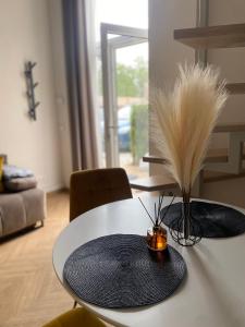 a dining room table with a feather centerpiece on it at Loftas Smilga in Palanga