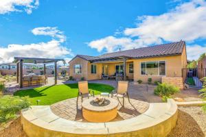 a home with a patio with chairs and a table at SPLASH-TASTIC FUN HOUSE in Indio