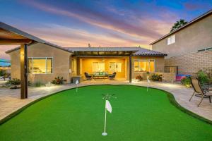 a house with a golf course in the yard at SPLASH-TASTIC FUN HOUSE in Indio