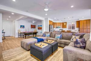 a living room with a couch and a pool table at SPLASH-TASTIC FUN HOUSE in Indio