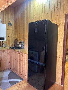 a kitchen with a refrigerator and a washing machine at Zenor in Quba +23 photos