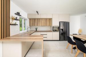 a kitchen with white cabinets and a wooden counter top at Villa Emili by IstriaLux in Svetvinčenat