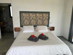 Giường trong phòng chung tại Cap KARAIB villa 2 chambres