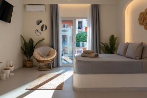 a bedroom with a bed and a door to a patio at IOSIF LUXURY ROOMS CENTER in Neos Marmaras