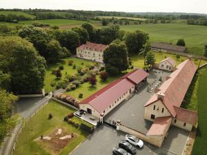 an aerial view of a large building with a red roof at Gite de groupe La Laiterie in Banneville-la-Campagne