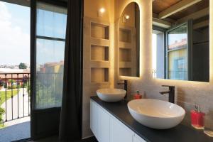 a bathroom with two sinks and a large window at PrimoPiano - Zumbini G in Milan +56 photos