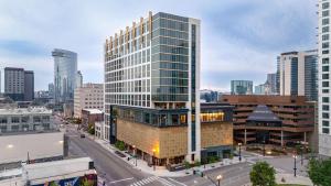 a rendering of a tall glass building in a city at Tempo By Hilton Nashville Downtown in Nashville