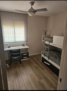 a bedroom with a desk and bunk beds and a bed and a window at La Cañada in Partida de La Cañada