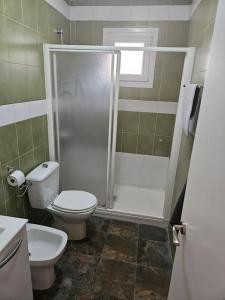 a bathroom with a shower and a toilet and a sink at La Cañada in Partida de La Cañada