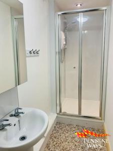 un bagno con un lavandino bianco e una doccia di The Old Courthouse Cottage, Haltwhistle a Haltwhistle Altre 8 foto