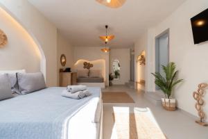 a bedroom with a large bed with towels on it at IOSIF LUXURY ROOMS CENTER in Neos Marmaras +76 photos