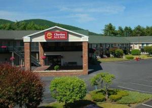 eine Vorderansicht eines Hotels mit einem Autohändler in der Unterkunft Clarion Inn & Suites at the Outlets of Lake George in Lake George