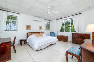 a bedroom with a bed and a desk and windows at Clearwater home in Saint Peter