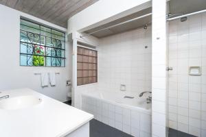 a bathroom with a tub and a sink and a window at Clearwater home in Saint Peter +8 photos