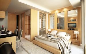 a bedroom with a large bed and a desk in it at Nam Talay Jomtien Beach - Rooftop Ocean View - Close to Beach, Pool & Gym in Na Jomtien