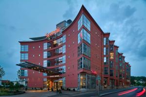 a red building with a hotel sign on it at Scandic Mölndal in Mölndal