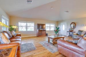 a living room with two couches and a table at On Lake Istokpoga Lorida Home with Lanai! in Sebring