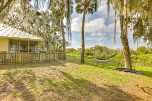 a house with a hammock in a yard at On Lake Istokpoga Lorida Home with Lanai! in Sebring
