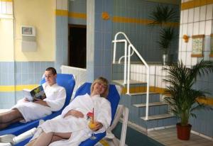 a man and a woman sitting in a chair in a room at Hotel Mohren in Ochsenhausen