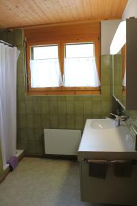 a bathroom with a sink and a window at Rietidylle mit atemberaubendem Blick auf die Churfirsten in Wildhaus +31 photos
