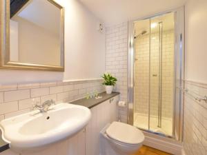 a bathroom with a sink and a toilet and a shower at The Bathurst Arms in Cirencester