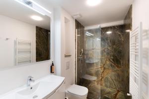 a bathroom with a toilet and a sink and a shower at Tomis 11 in Constanţa +116 photos