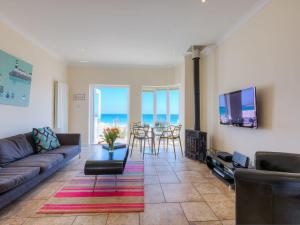 a living room with a couch and a table at Seaspray in St Ives