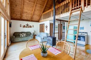 a living room with a table and a stove at 3BR cabin w scenic deck and pet-friendly in Great Cacapon