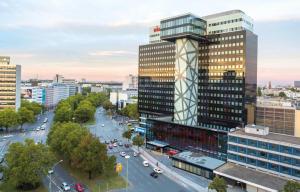 a large building with a clock on the side of it at Riu Plaza Berlin in Berlin