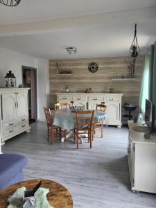 a living room with a table and chairs at ENTRE Terre ET Mer in Saint-Aubin-le-Cauf