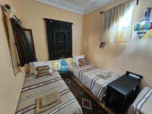 Ένα ή περισσότερα κρεβάτια σε δωμάτιο στο Riad Dar Rita